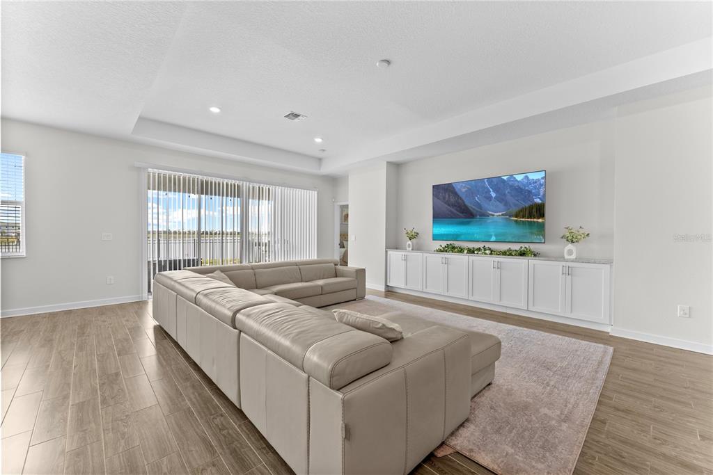 2926 Wordsmith Road Kissimmee, FL 34746 - Photo 14 of 42 a living room with furniture and a flat screen tv