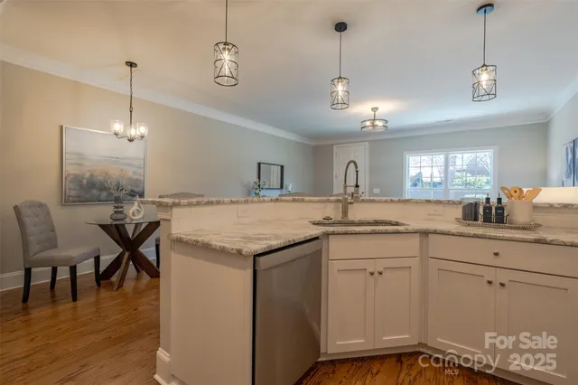a kitchen with a table chairs and white cabinets