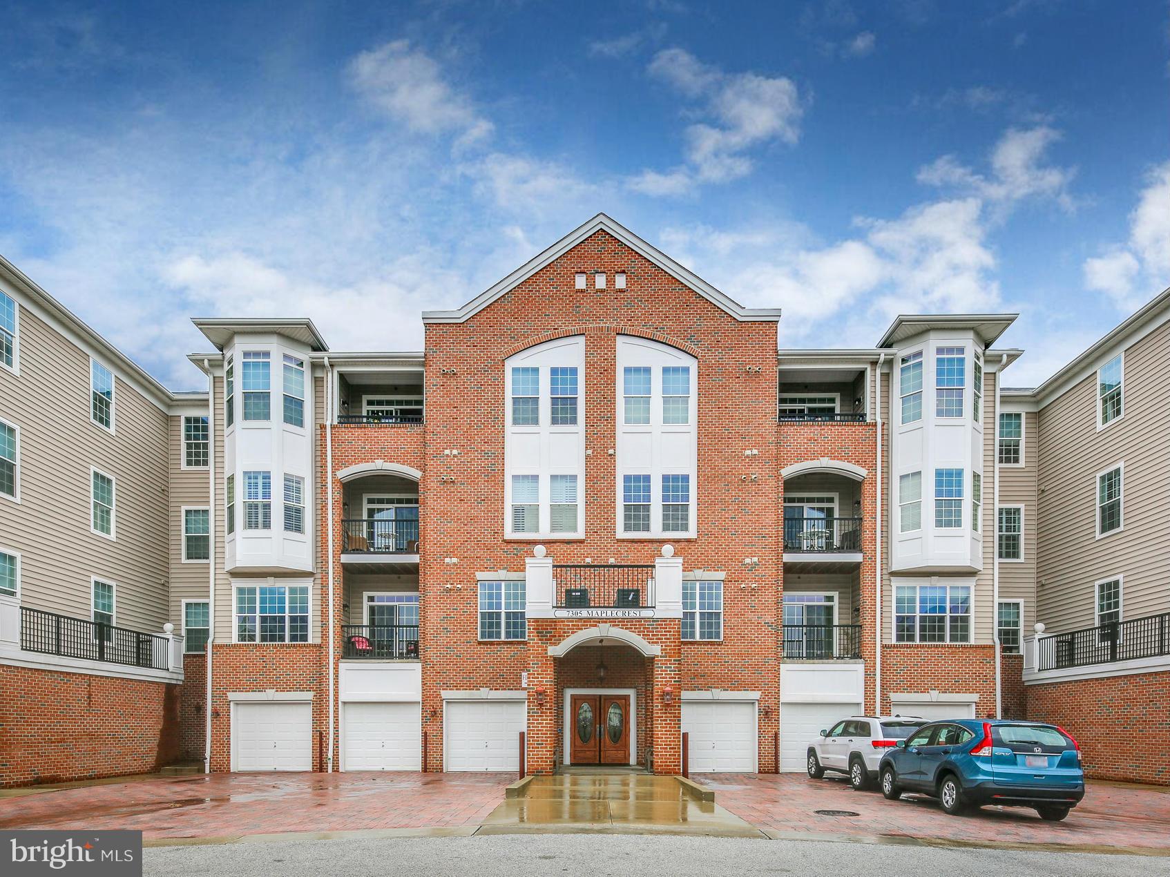 7305 Maplecrest Road, Unit 208 Elkridge, MD 21075 - Photo 1 of 30 a front view of a residential apartment building with a yard