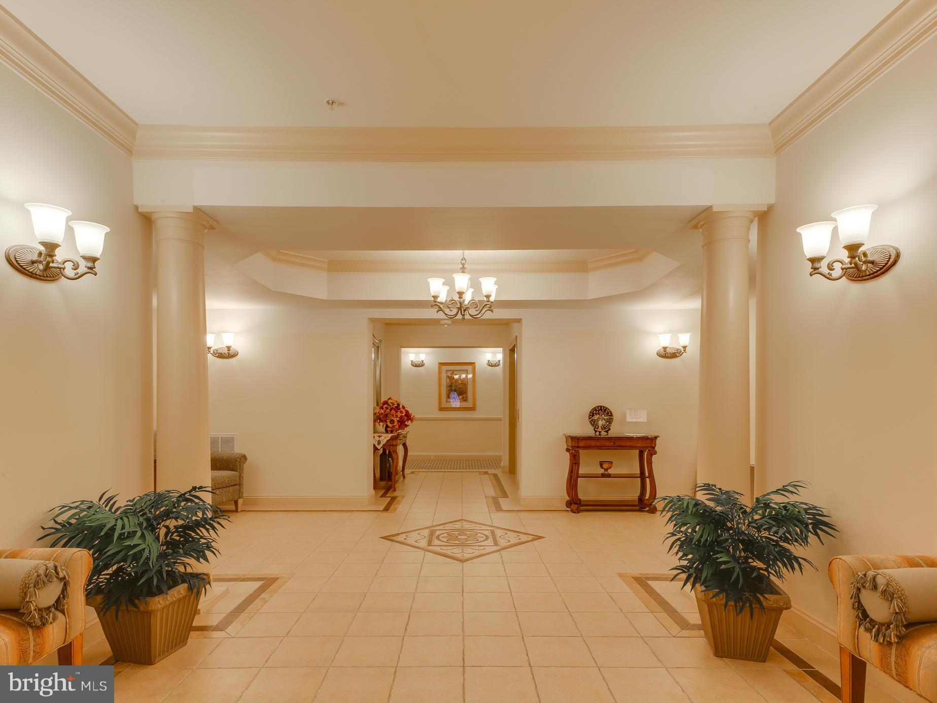 7305 Maplecrest Road, Unit 208 Elkridge, MD 21075 - Photo 3 of 30 a view of a hallway to a livingroom and a couch