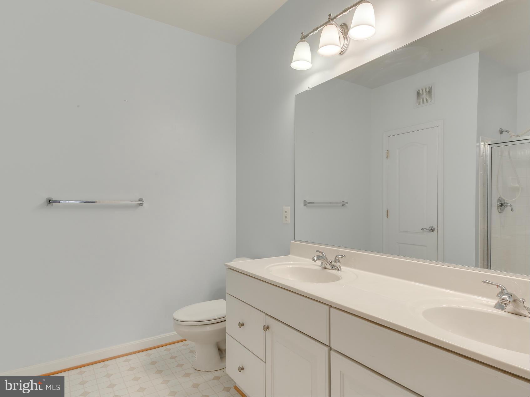 7305 Maplecrest Road, Unit 208 Elkridge, MD 21075 - Photo 21 of 30 a bathroom with a sink a toilet and a mirror