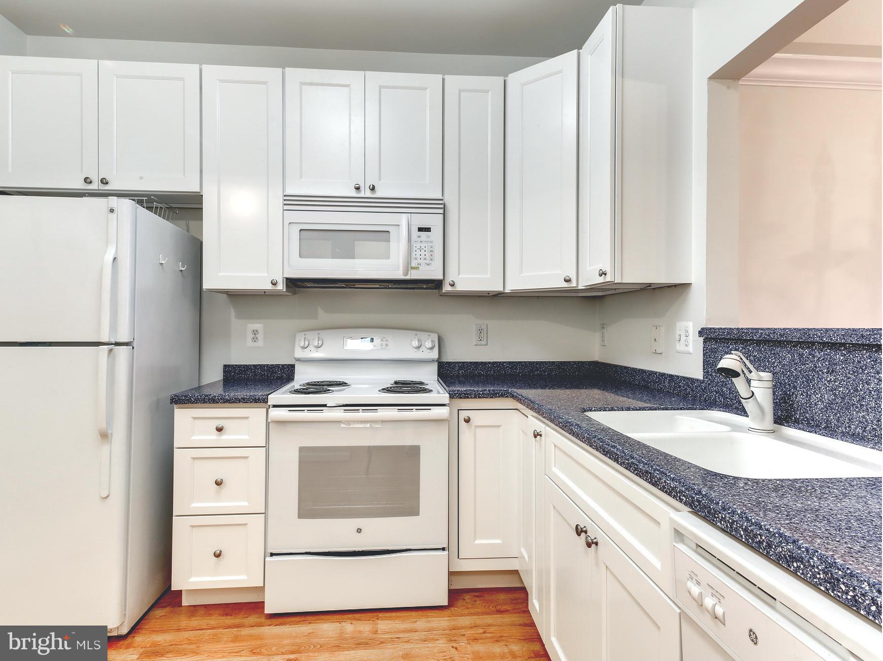 7305 Maplecrest Road, Unit 208 Elkridge, MD 21075 - Photo 10 of 30 a kitchen with granite countertop a sink stove and refrigerator