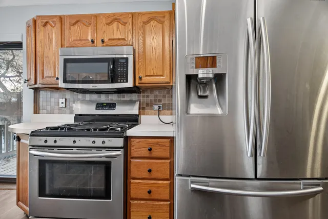 a kitchen with stainless steel appliances a stove and a microwave
