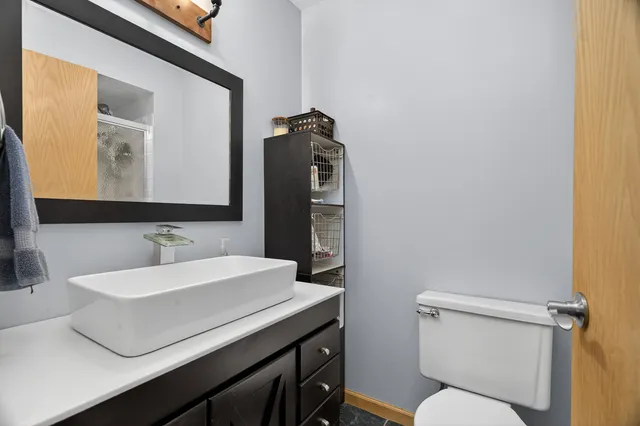 a bathroom with a sink toilet and mirror