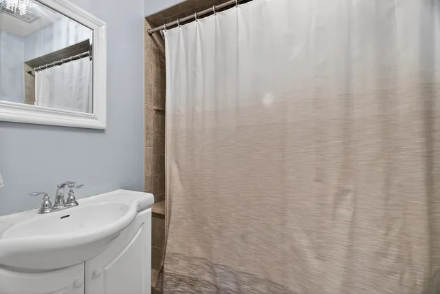 a bathroom with a sink a mirror and a vanity