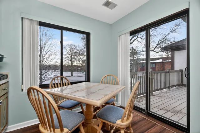 a view of a dining room with furniture large windows and wooden floor