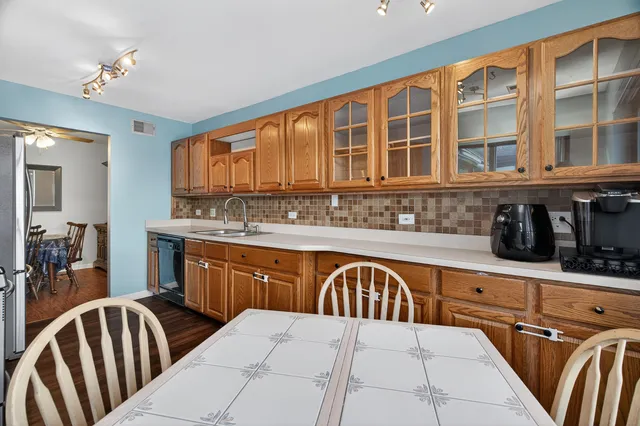 a kitchen with stainless steel appliances granite countertop a sink and cabinets