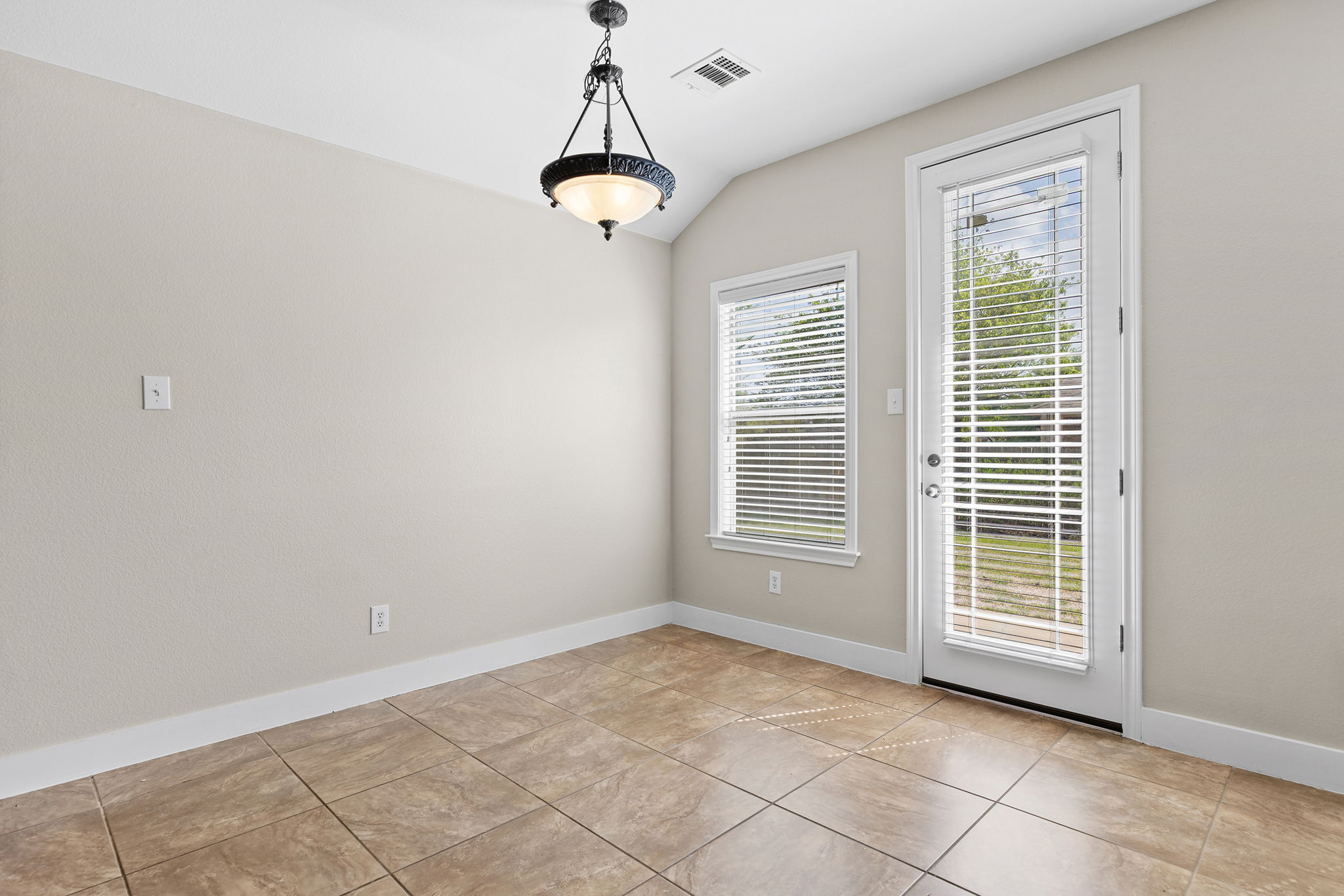 3013 Hawks Swoop Trail Pflugerville, TX 78660 - Photo 21 of 38 Unfurnished dining area featuring vaulted ceiling and light tile patterned floors