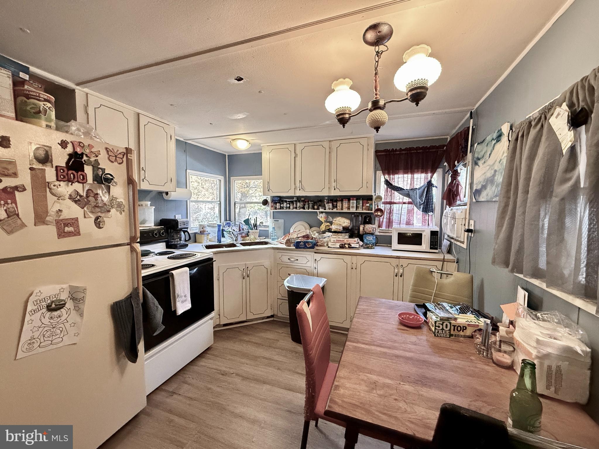 250 Jute Road Millville, NJ 08332 - Photo 6 of 11 a kitchen with stainless steel appliances granite countertop a stove a sink dishwasher a refrigerator white cabinets and wooden floor