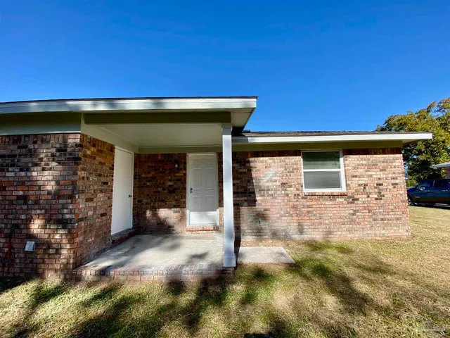 a view of a door of the house with outdoor space