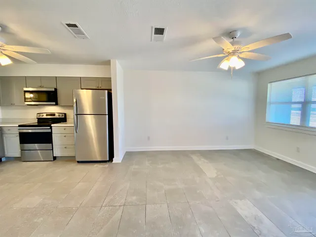 a kitchen with a refrigerator a microwave and a stove
