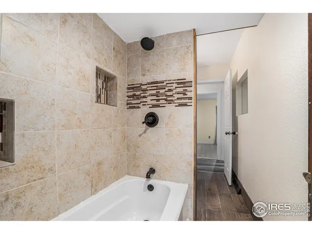 a bathroom with a shower and a tub