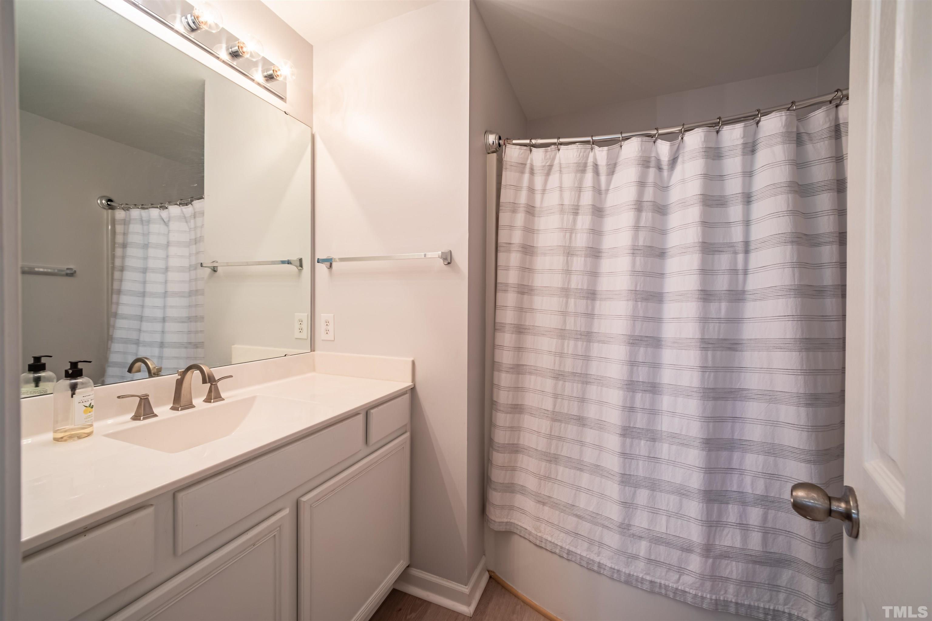8447 Central Drive Raleigh, NC 27613 - Photo 12 of 19 a bathroom with a sink and a mirror