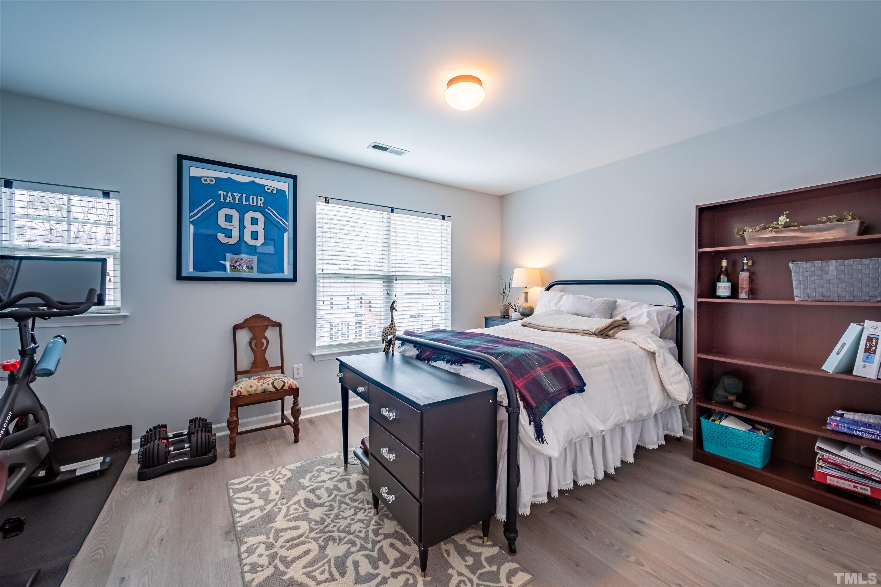 8447 Central Drive Raleigh, NC 27613 - Photo 13 of 19 a bedroom with a bed and a tv on table