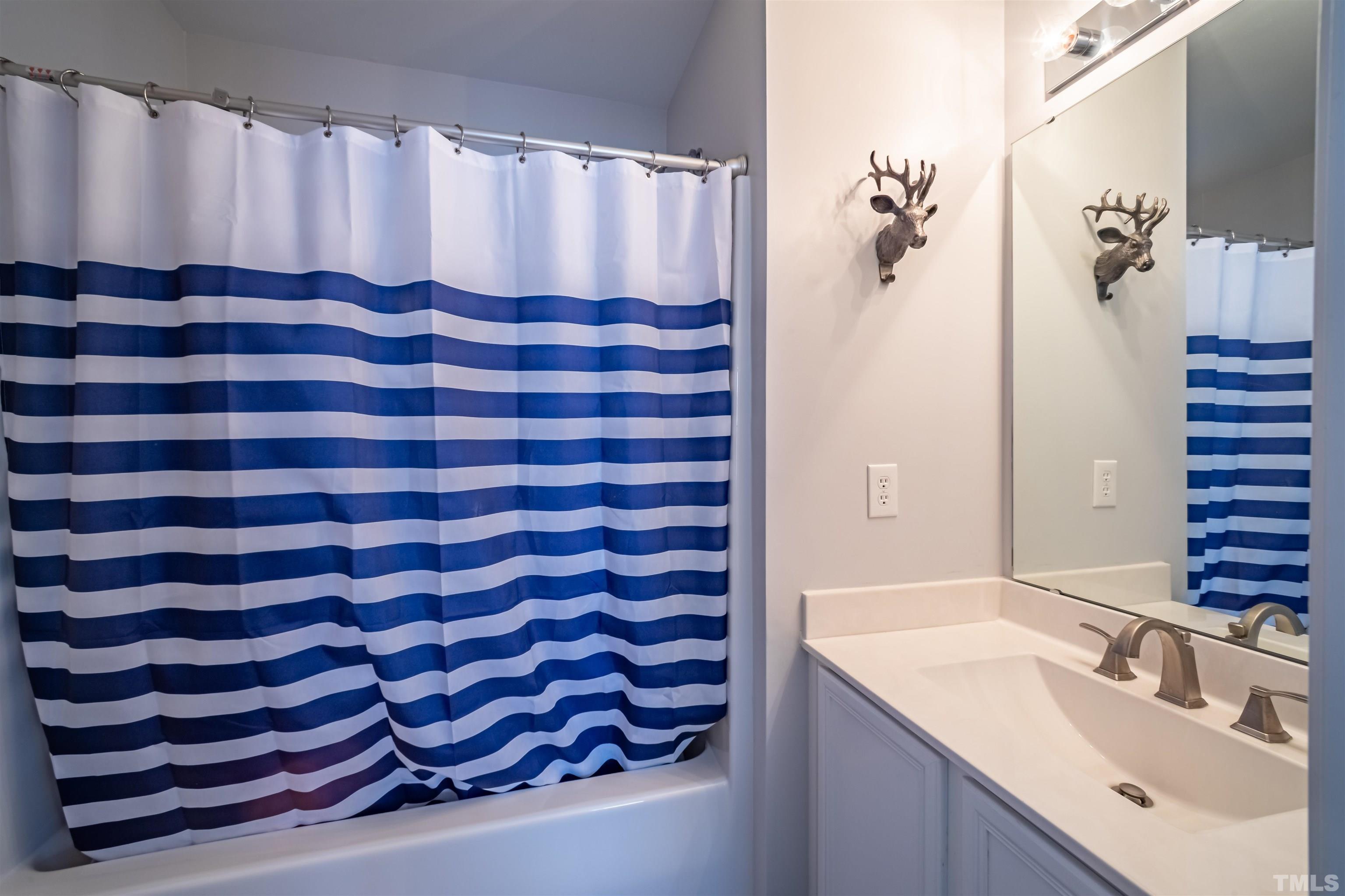 8447 Central Drive Raleigh, NC 27613 - Photo 15 of 19 a bathroom with a sink and a mirror
