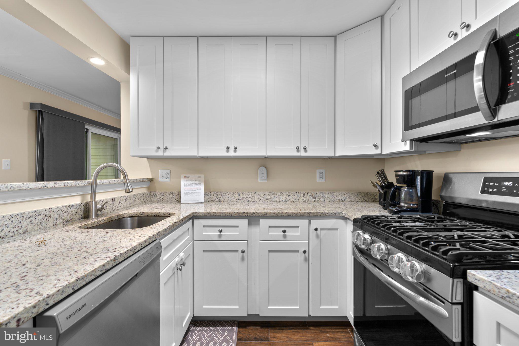 125 Timberbrook Lane, Unit T2 Gaithersburg, MD 20878 - Photo 15 of 30 a kitchen with granite countertop a sink stove and cabinets