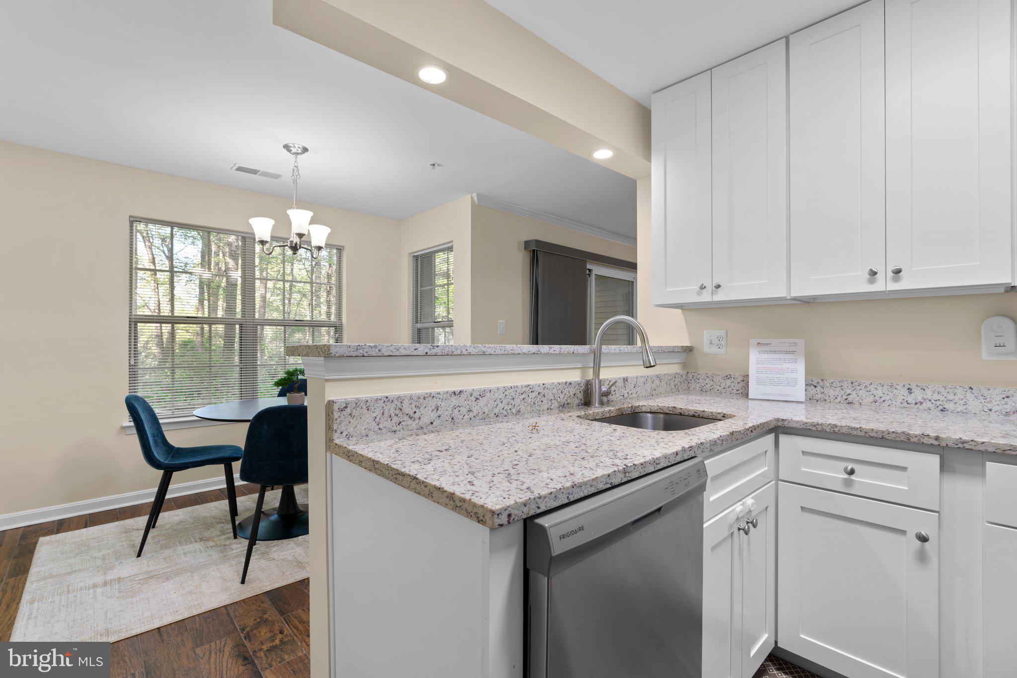 125 Timberbrook Lane, Unit T2 Gaithersburg, MD 20878 - Photo 16 of 30 a kitchen with center island table and chairs