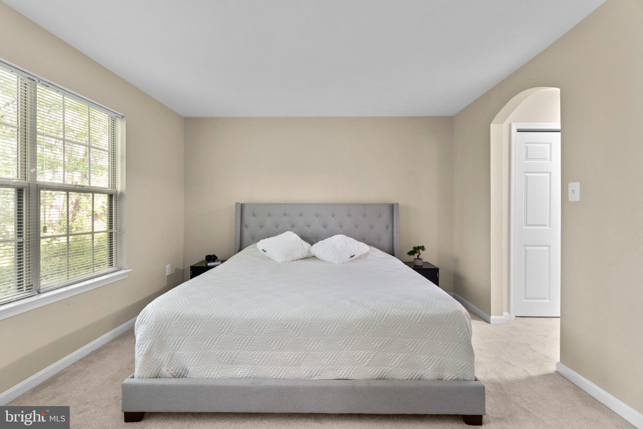 125 Timberbrook Lane, Unit T2 Gaithersburg, MD 20878 - Photo 19 of 30 a large white bed in a room next to a window