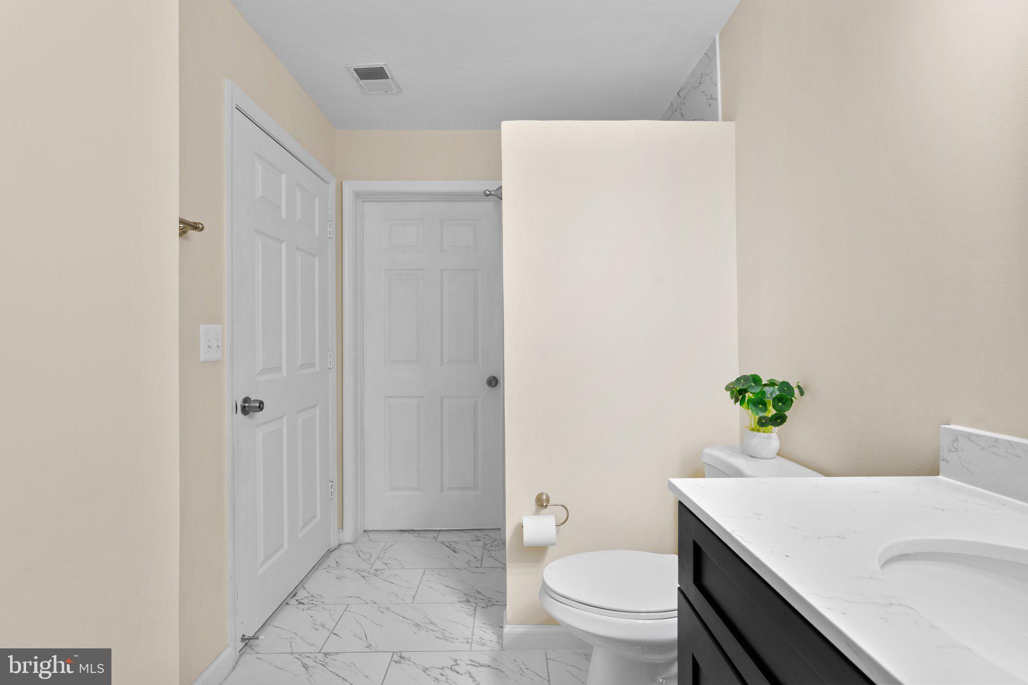 125 Timberbrook Lane, Unit T2 Gaithersburg, MD 20878 - Photo 21 of 30 a bathroom with a sink a toilet and shower