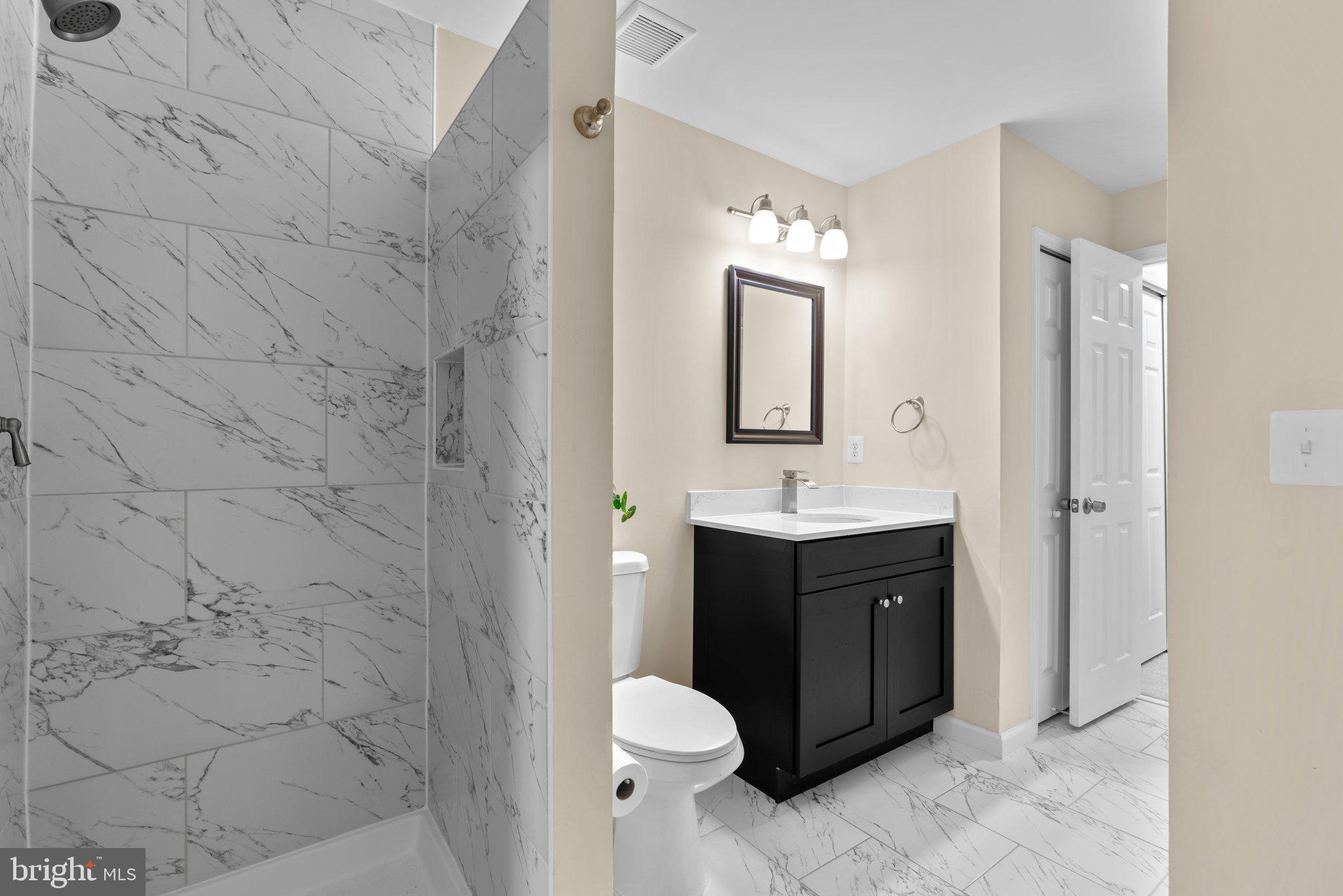 125 Timberbrook Lane, Unit T2 Gaithersburg, MD 20878 - Photo 22 of 30 a bathroom with a sink and a mirror