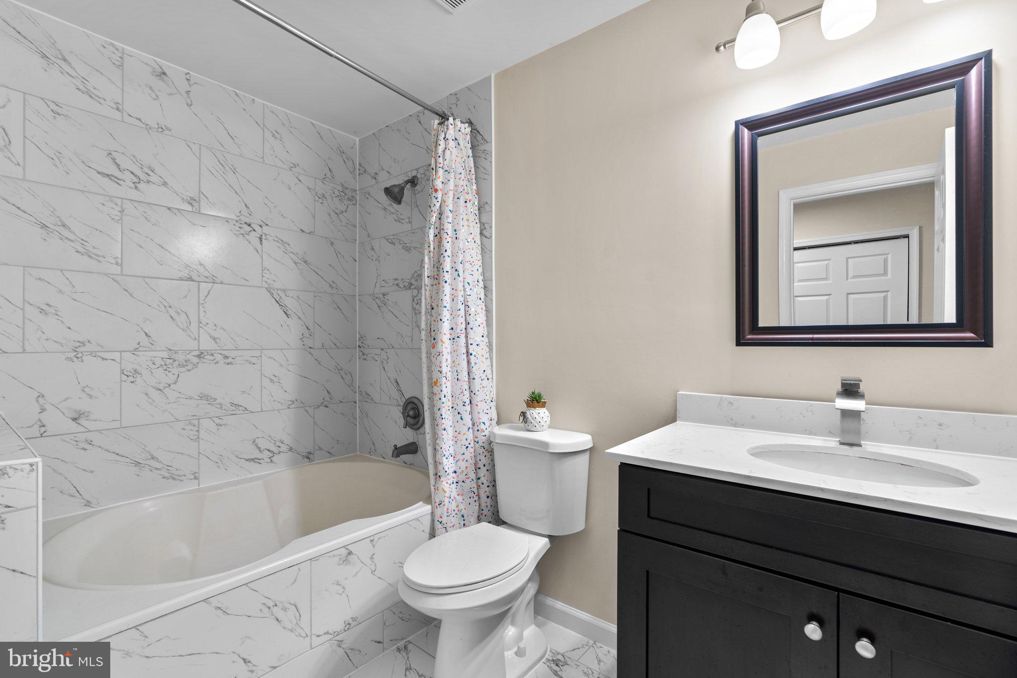 125 Timberbrook Lane, Unit T2 Gaithersburg, MD 20878 - Photo 26 of 30 a bathroom with a sink toilet a mirror and bathtub