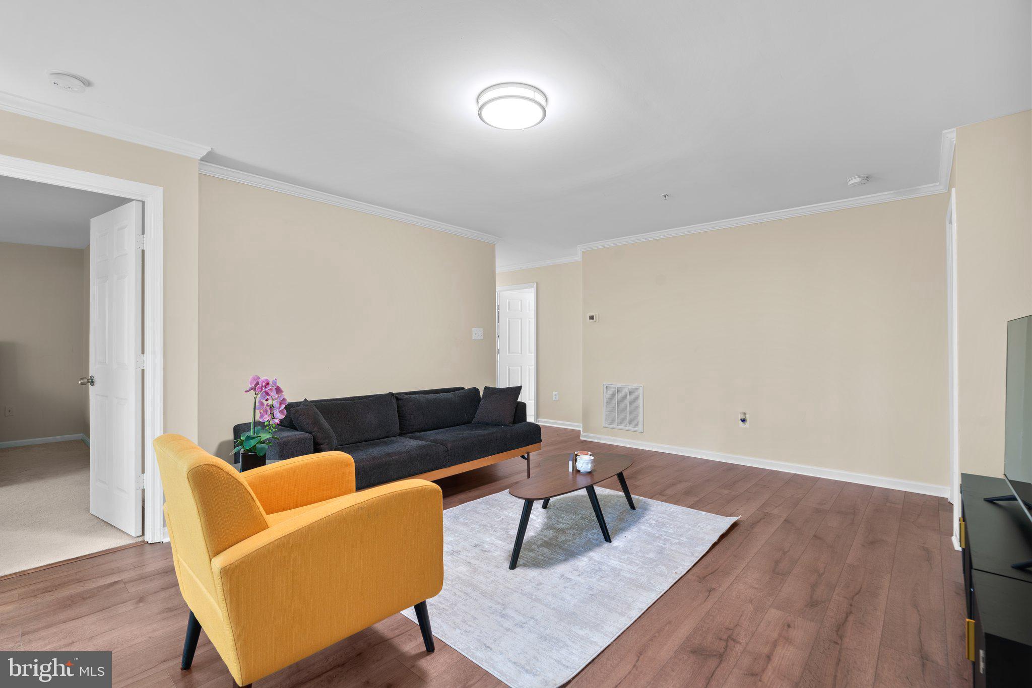 125 Timberbrook Lane, Unit T2 Gaithersburg, MD 20878 - Photo 7 of 30 a living room with furniture and a wooden floor