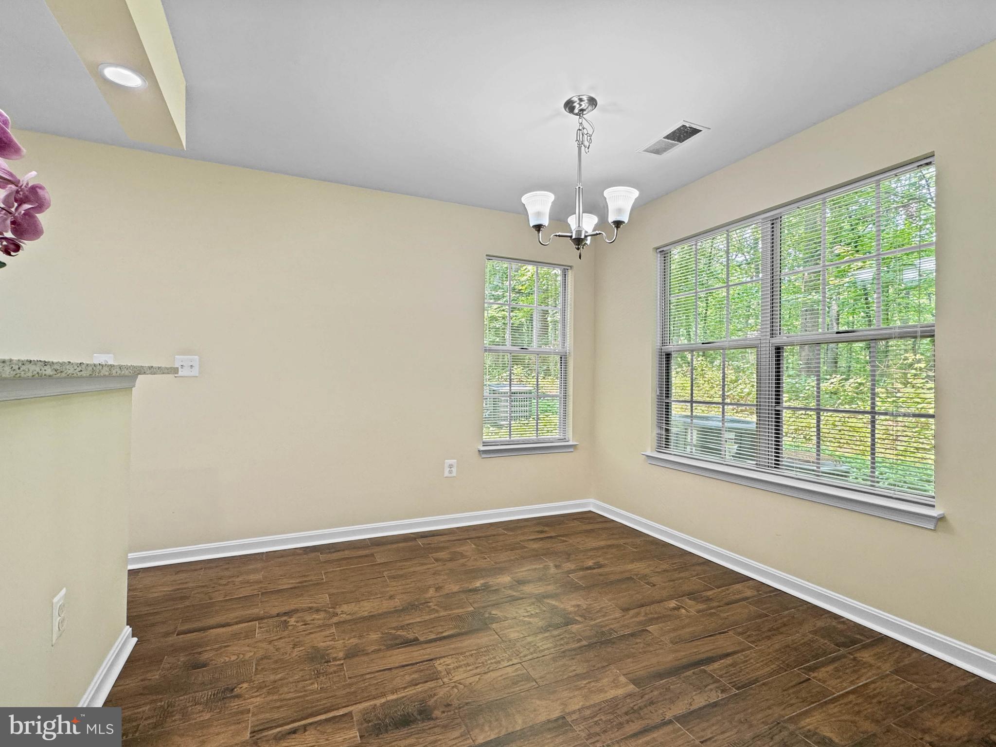 125 Timberbrook Lane, Unit T2 Gaithersburg, MD 20878 - Photo 9 of 30 a view of an empty room with wooden floor and a window