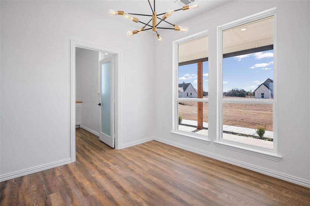 3093 Willow Road Celeste, TX 75423 - Photo 21 of 40 an empty room with wooden floor fan and windows