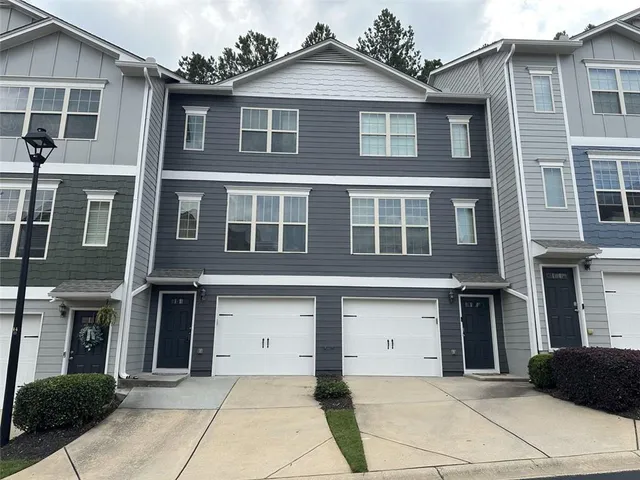 a view of a brick house with many windows