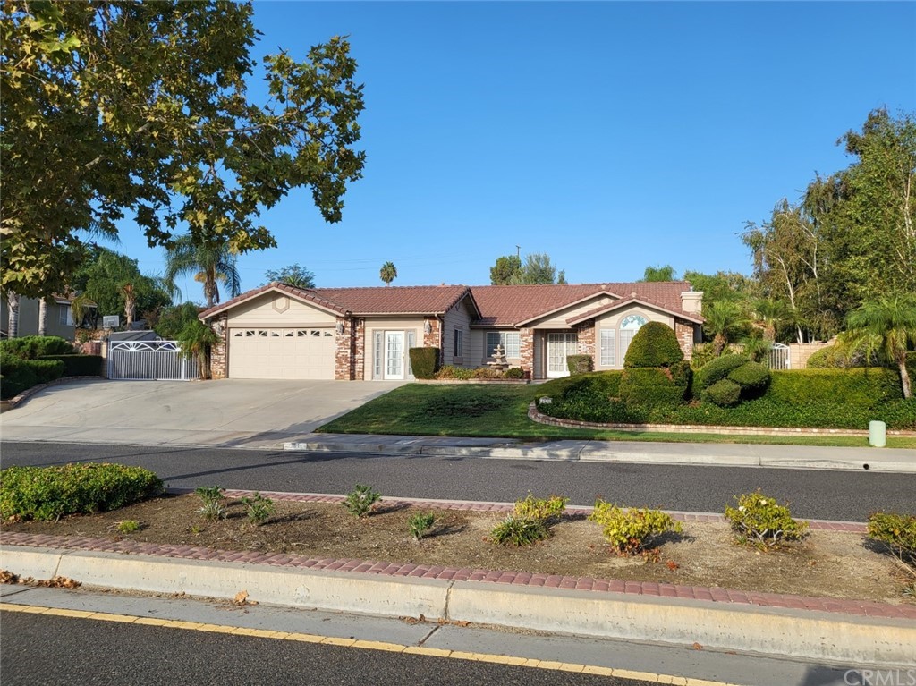 6781 Mission Grove Riverside, CA 92506 - Photo 1 of 1 a front view of a house with a yard and garage