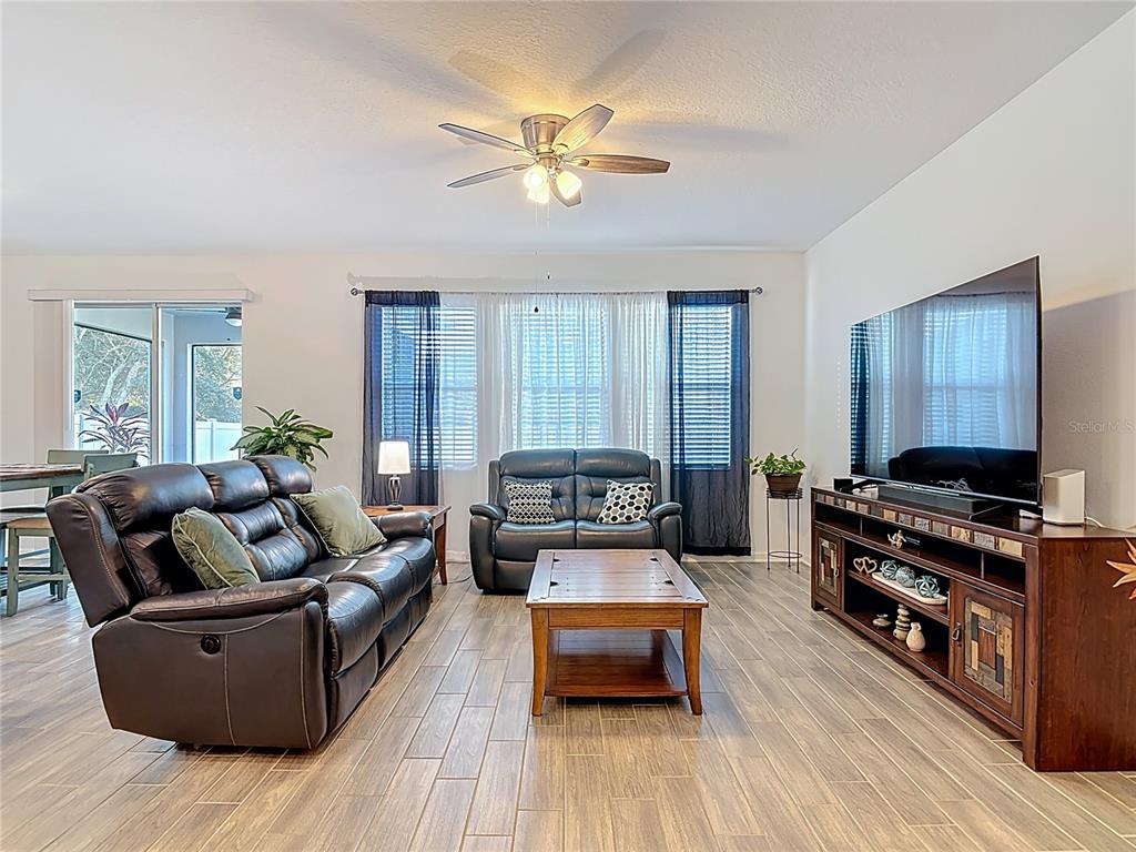 5704 Bristleleaf Court Leesburg, FL 34748 - Photo 13 of 41 a living room with furniture and a flat screen tv
