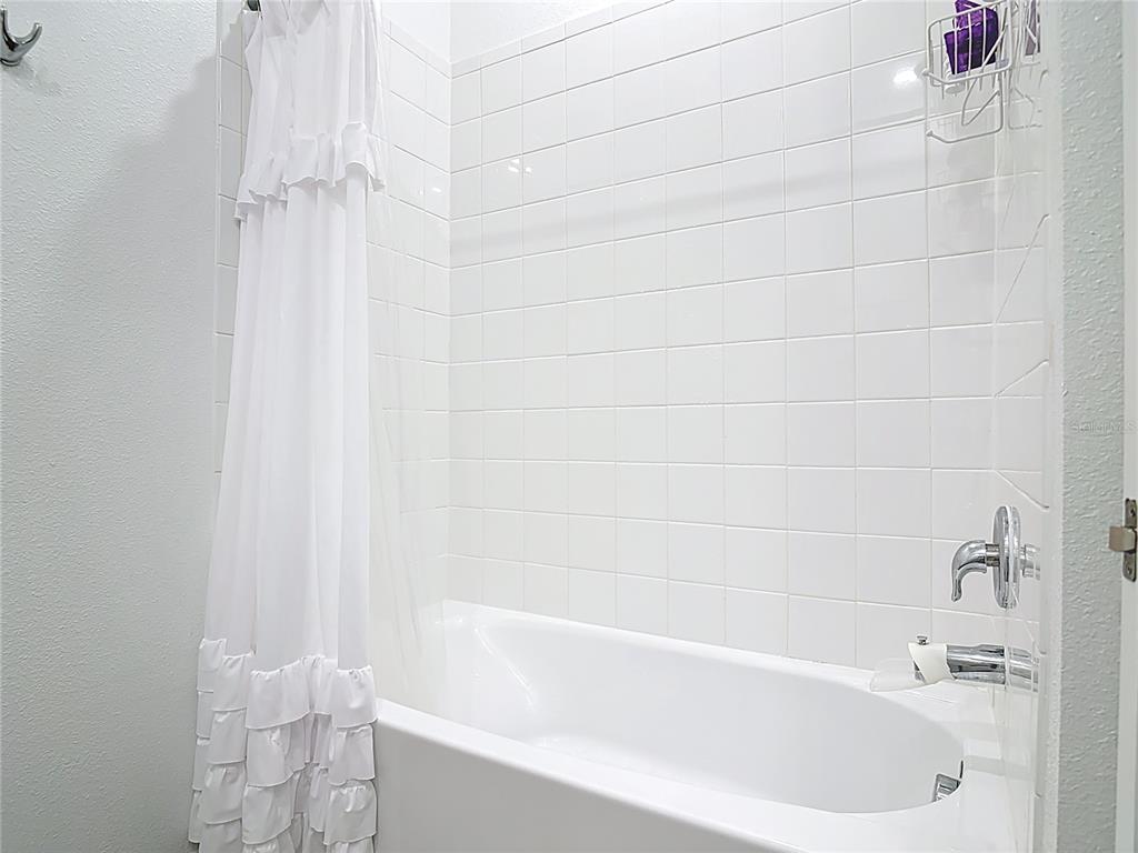 5704 Bristleleaf Court Leesburg, FL 34748 - Photo 20 of 41 a bathroom with a bathtub