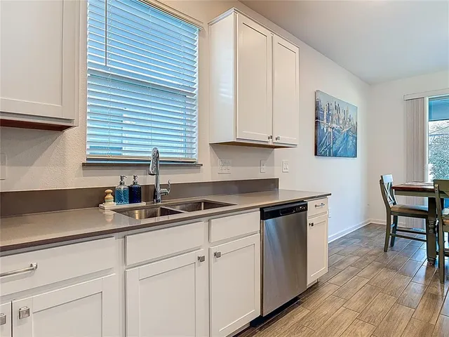 a kitchen with sink cabinets and wooden floor