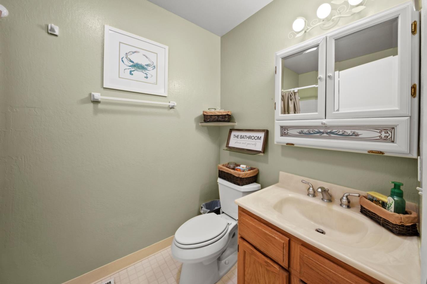 4 Primrose Circle Seaside, CA 93955 - Photo 16 of 22 a bathroom with a toilet sink and mirror