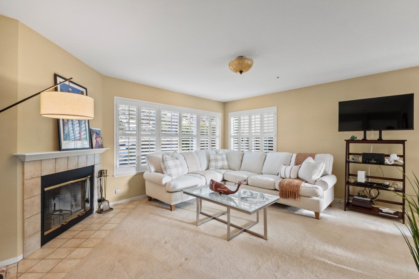 4 Primrose Circle Seaside, CA 93955 - Photo 3 of 22 a living room with furniture a flat screen tv and a fireplace