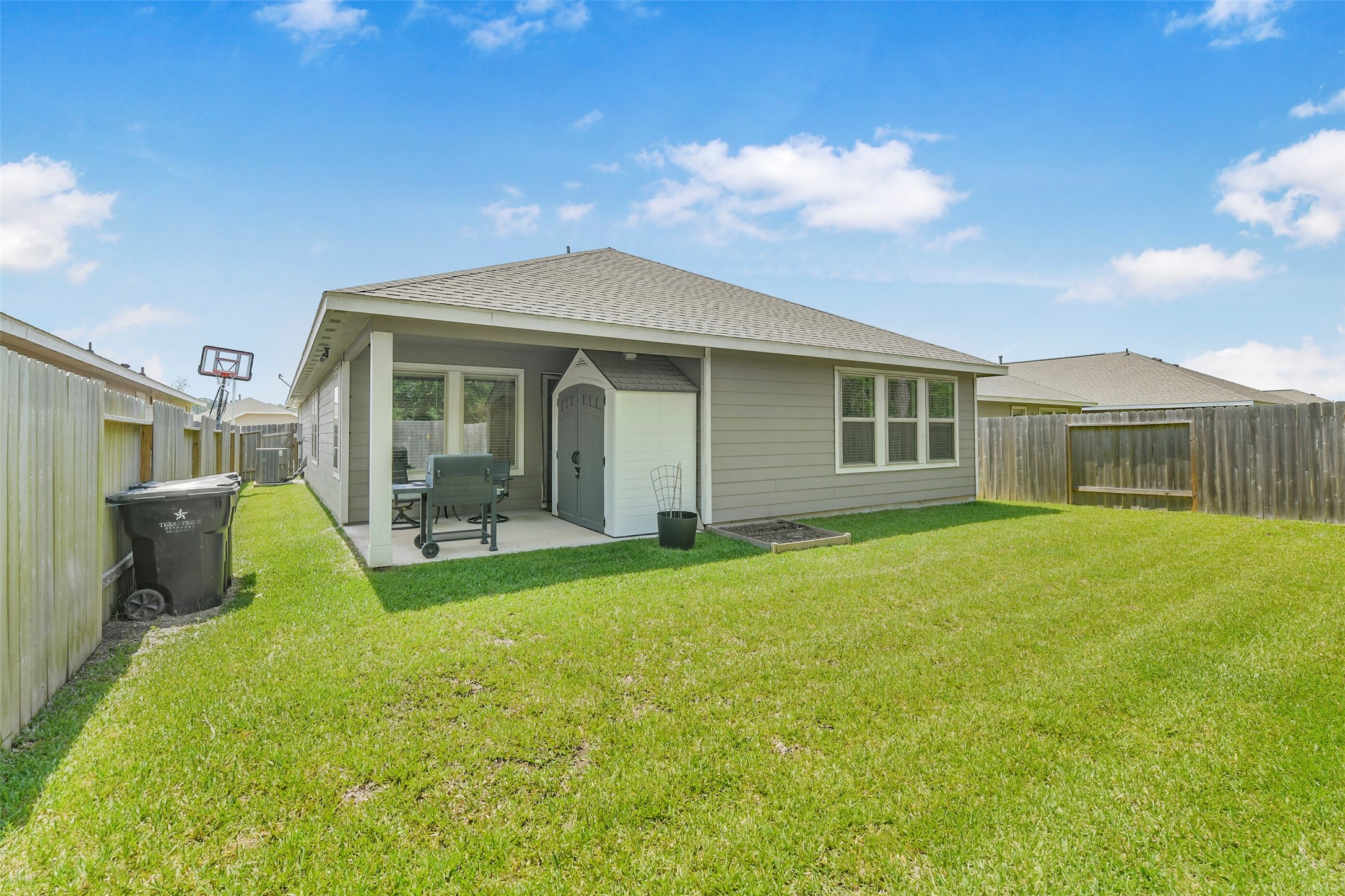 13978 Manatee Street Splendora, TX 77372 - Photo 31 of 39 Outdoor covered patio and storage shed providing additional storage and functionality.