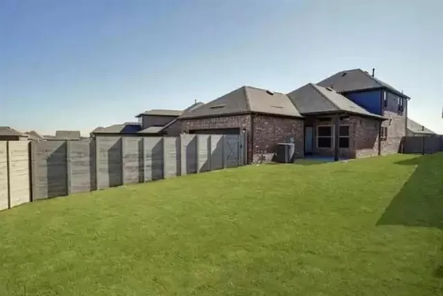a view of a house with a yard and sitting area