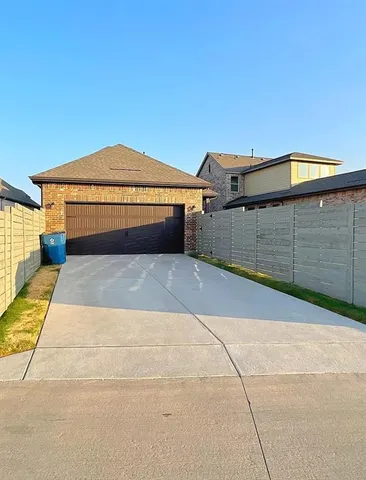 a backyard of a house with a garage