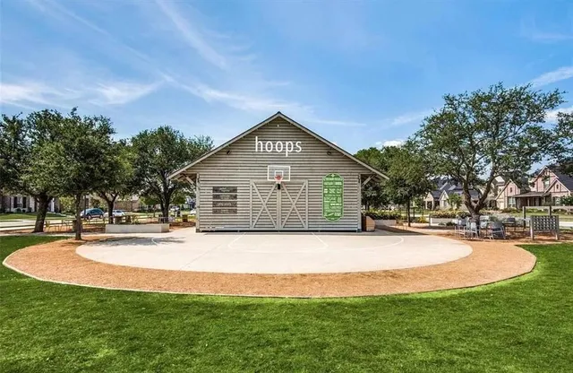 a front view of house with yard and trees in the background