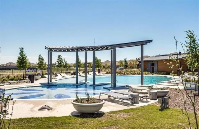 a living room with patio furniture and a potted plant