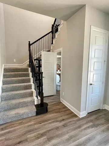 a view of entryway with wooden floor and stairs