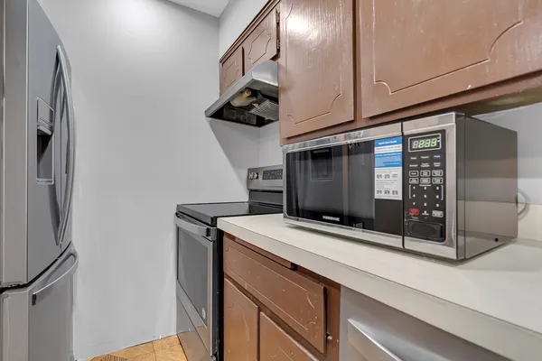 a kitchen with stainless steel appliances a sink and a refrigerator