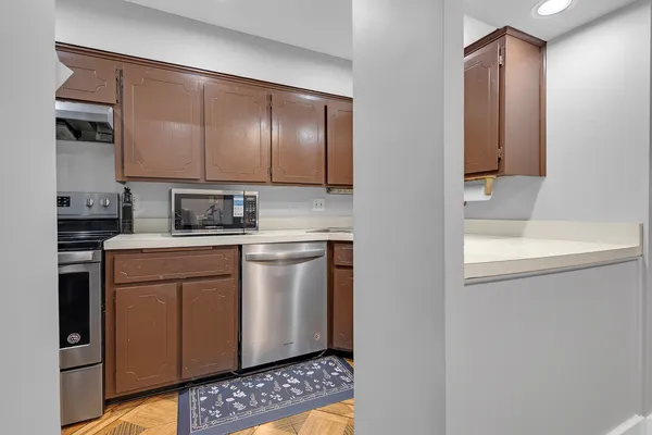 a kitchen with stainless steel appliances a sink and a microwave