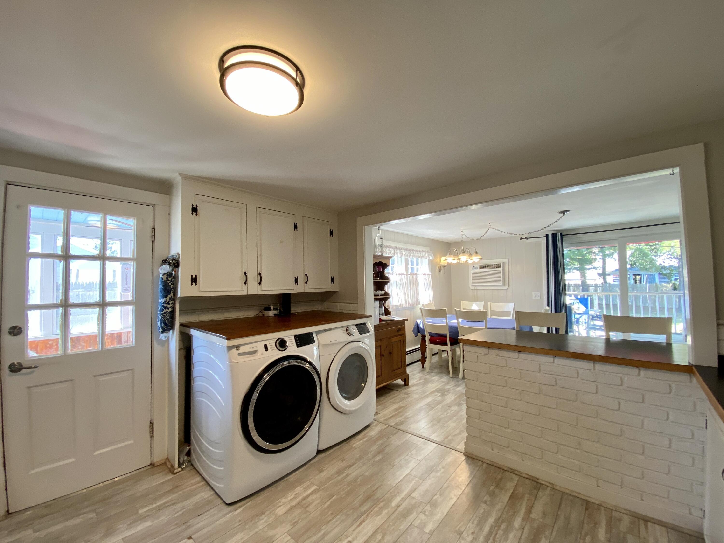 23 Naushon Road Dennis Port, MA 02639 - Photo 11 of 31 a living room with furniture a flat screen tv and large window