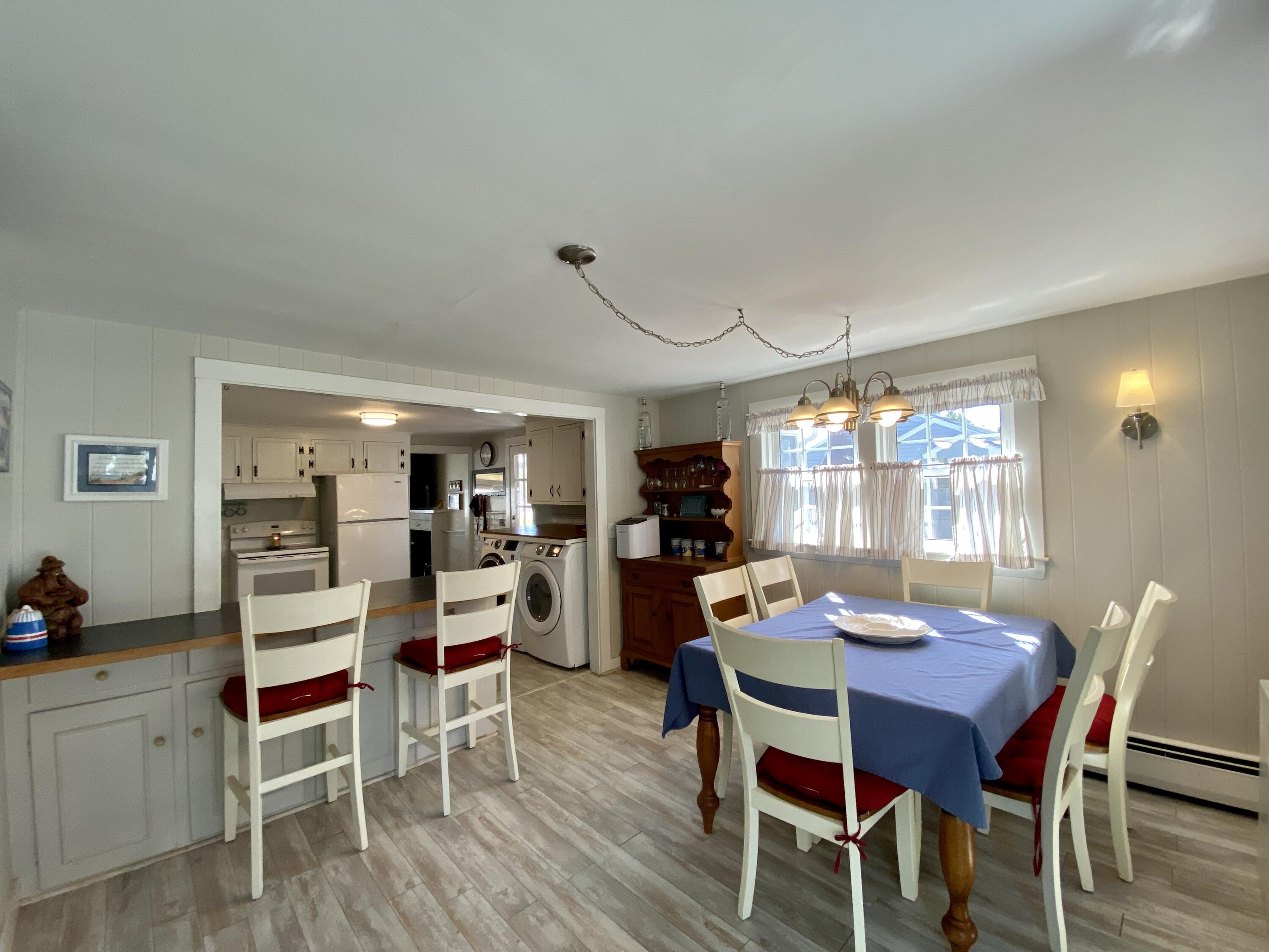 23 Naushon Road Dennis Port, MA 02639 - Photo 12 of 31 a view of a dining room with furniture and wooden floor