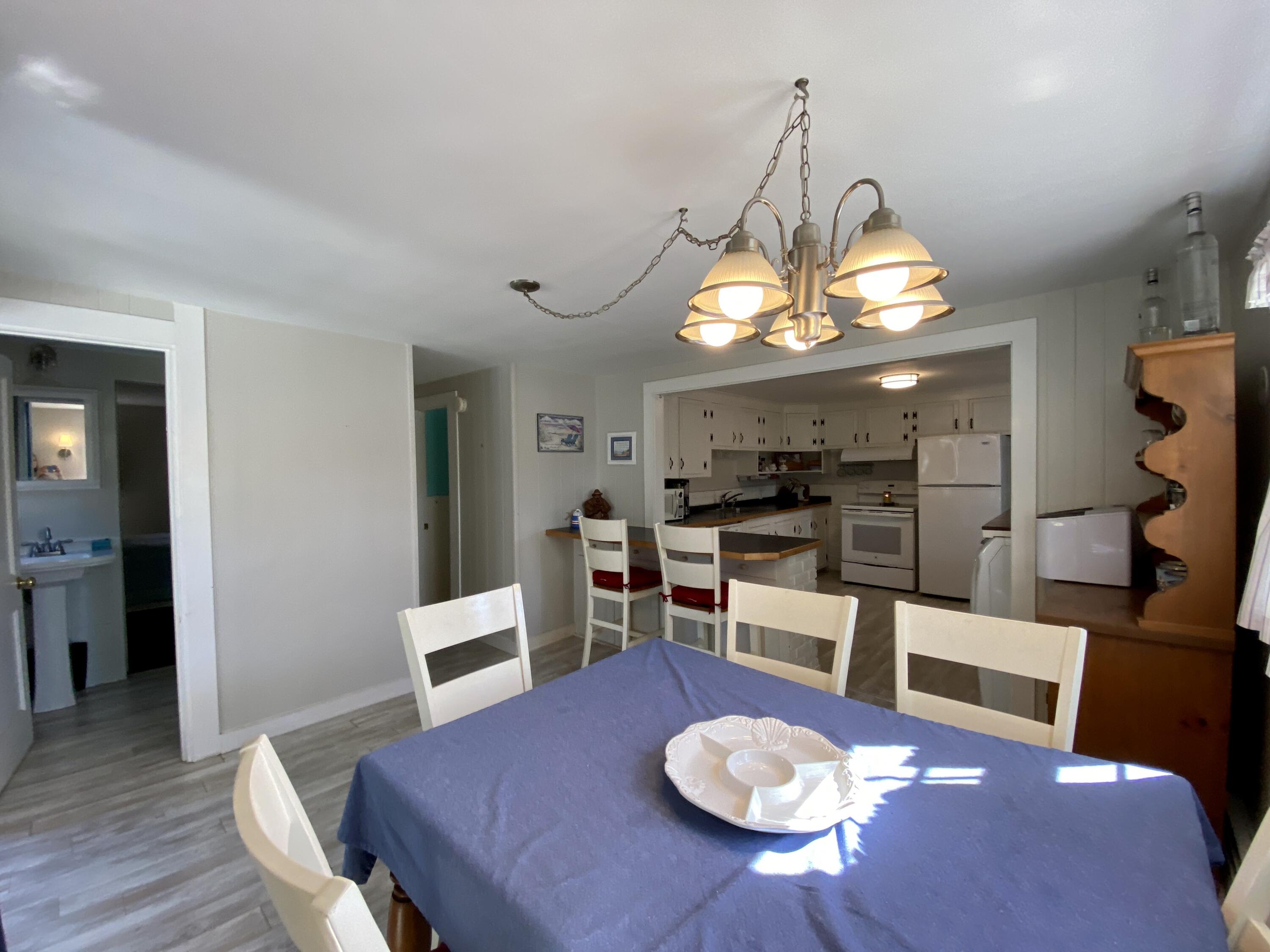 23 Naushon Road Dennis Port, MA 02639 - Photo 15 of 31 a view of a dining room with furniture and wooden floor