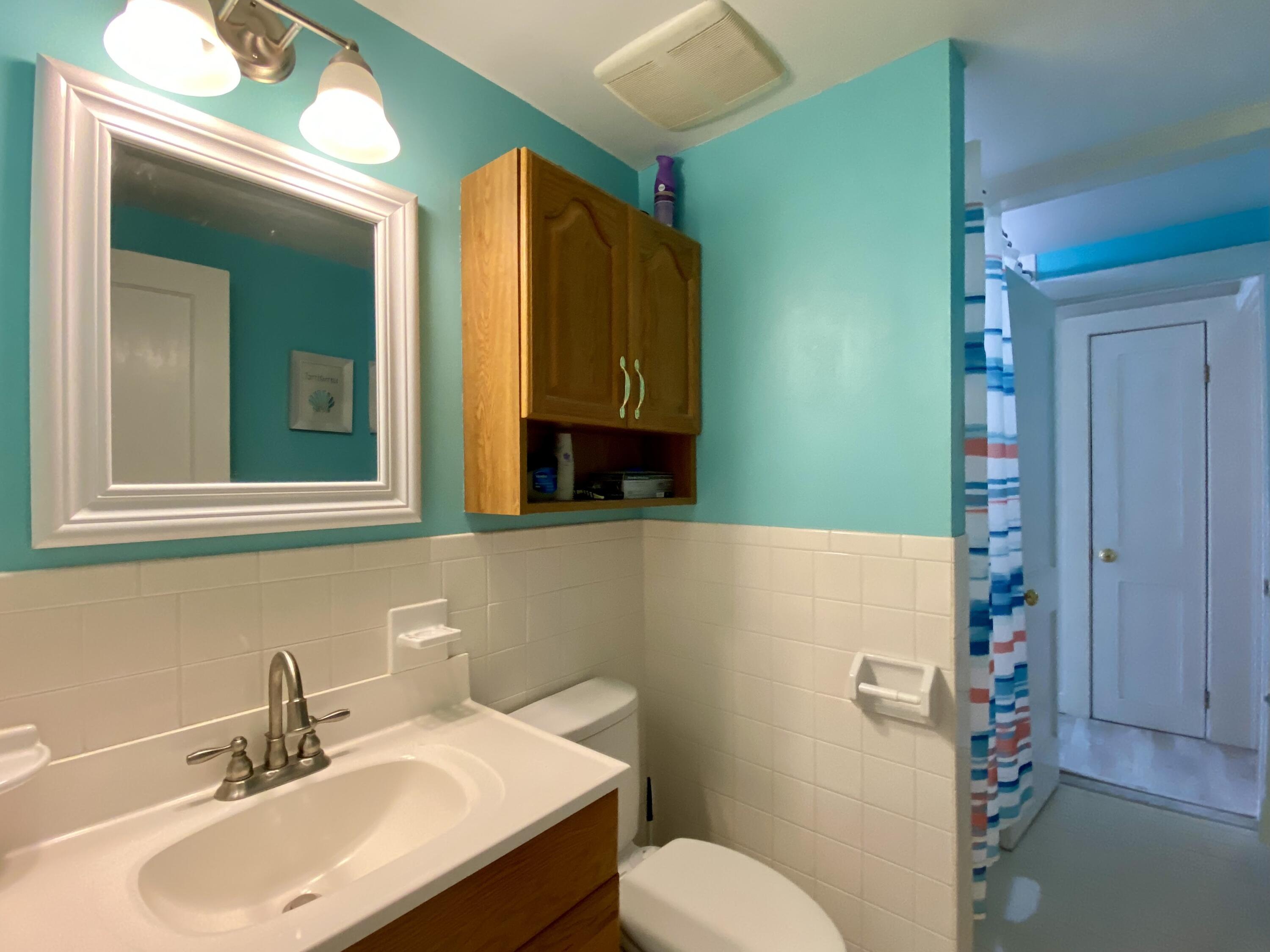 23 Naushon Road Dennis Port, MA 02639 - Photo 24 of 31 a bathroom with a sink toilet and mirror