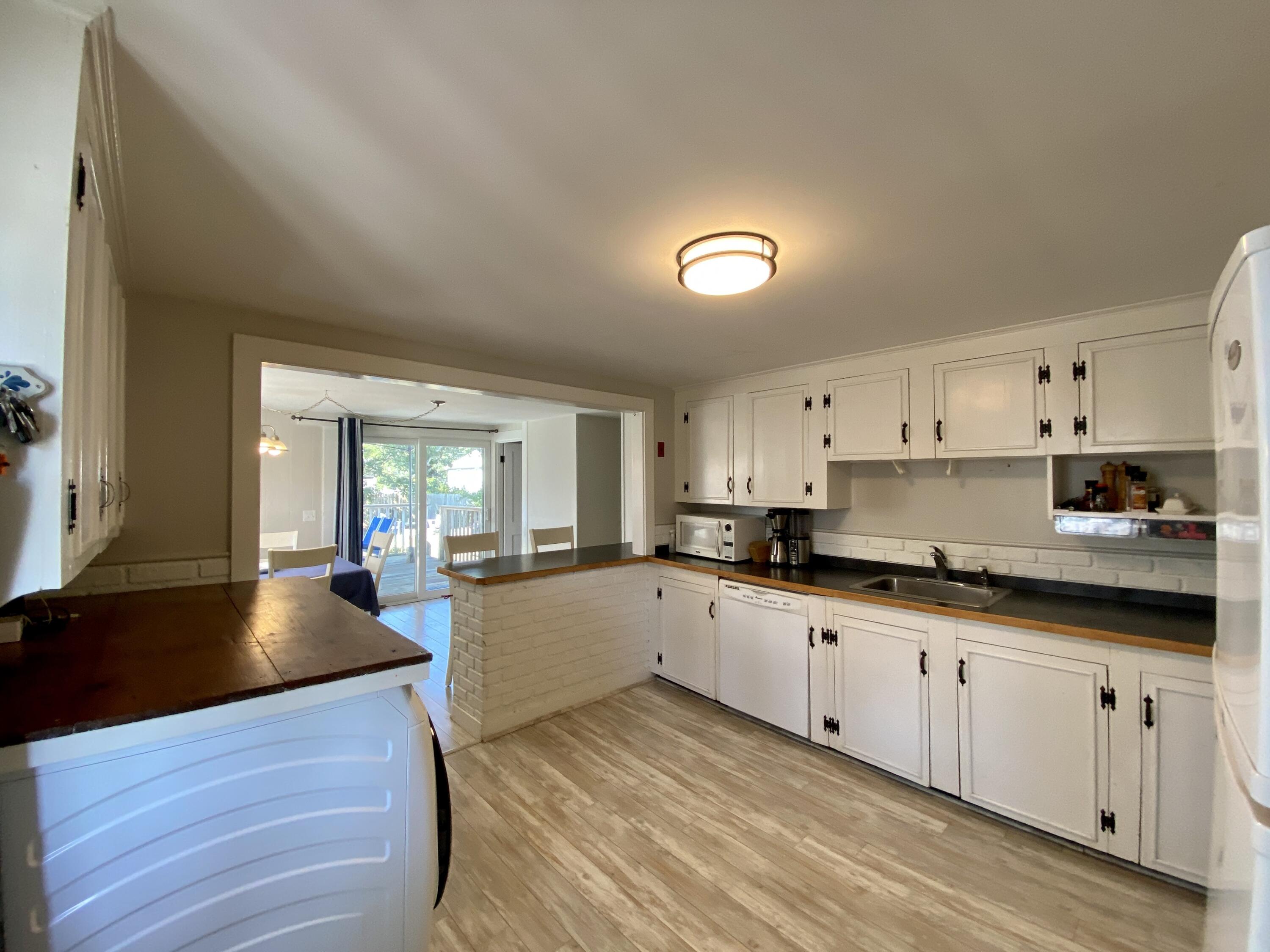 23 Naushon Road Dennis Port, MA 02639 - Photo 8 of 31 a large kitchen with cabinets a sink and appliances