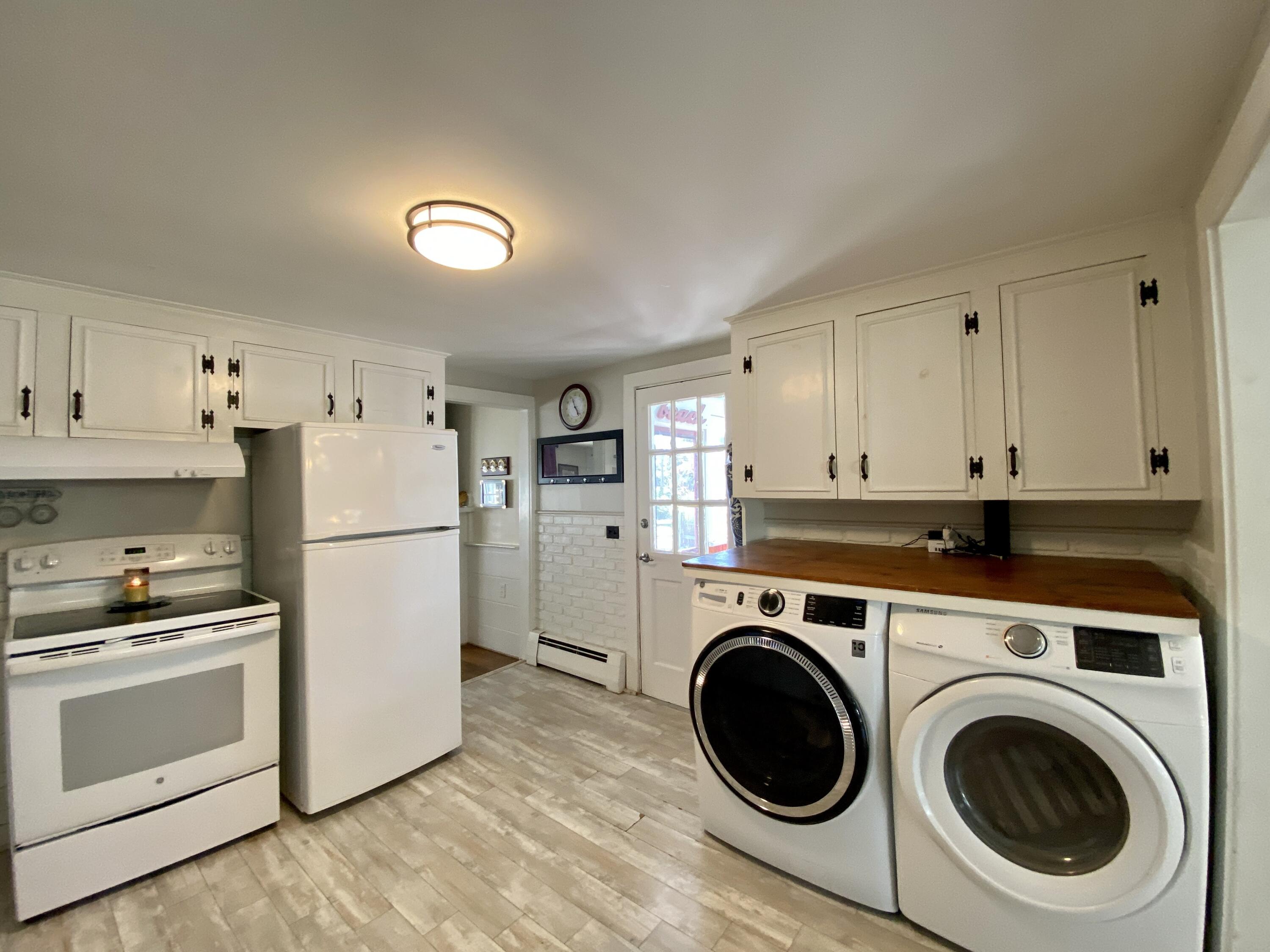 23 Naushon Road Dennis Port, MA 02639 - Photo 10 of 31 a kitchen with a refrigerator sink stove and cabinets