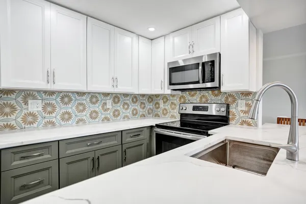 a kitchen with a sink stove and microwave